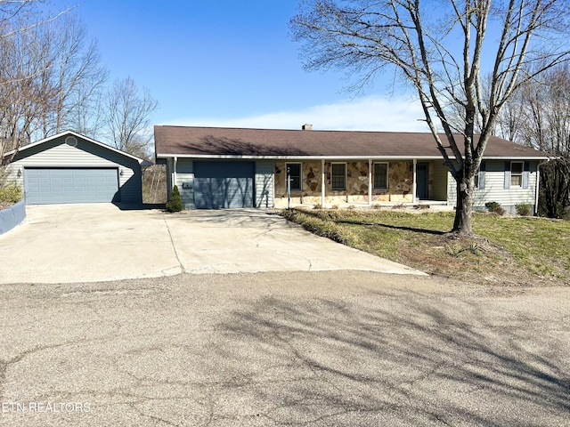 ranch-style house with a detached garage and stone siding