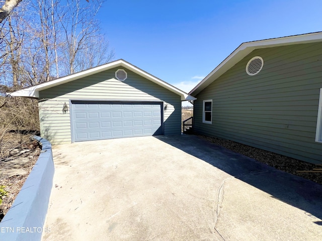 exterior space with a garage and an outdoor structure