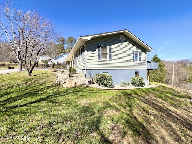 view of home's exterior with a lawn