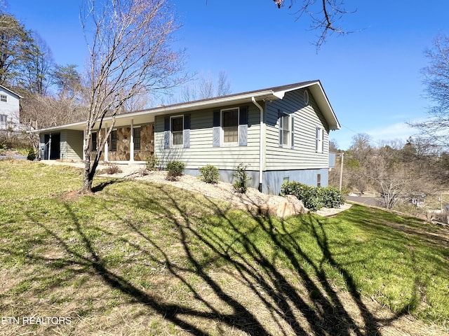 view of front of property with stone siding and a front yard