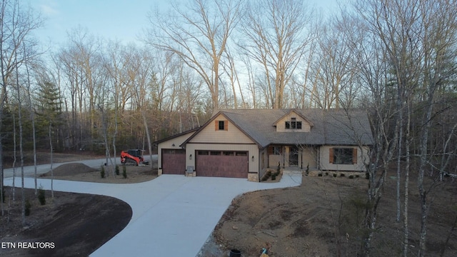 view of front of house with a garage and stone siding