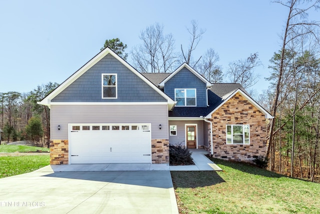 craftsman-style house with concrete driveway, a front lawn, and stone siding