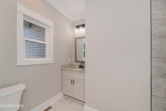 half bathroom featuring vanity, visible vents, baseboards, crown molding, and toilet