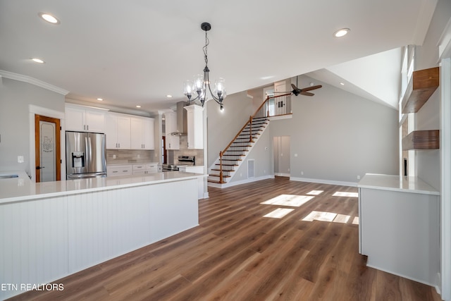 kitchen with backsplash, dark wood-type flooring, light countertops, appliances with stainless steel finishes, and white cabinetry