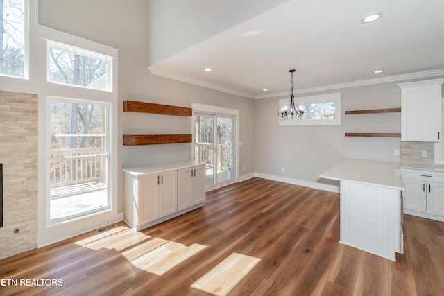 interior space featuring visible vents, crown molding, dark wood-type flooring, and an inviting chandelier