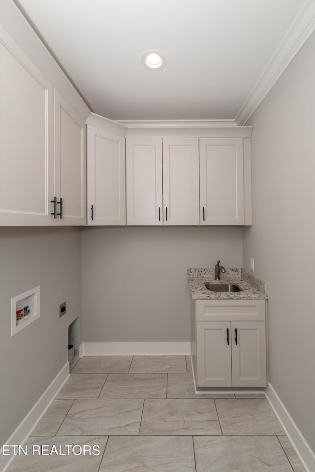 clothes washing area with washer hookup, ornamental molding, cabinet space, hookup for an electric dryer, and a sink