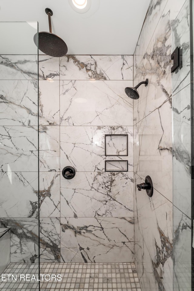 full bath featuring a marble finish shower