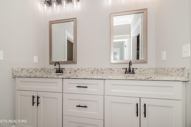 bathroom featuring double vanity and a sink