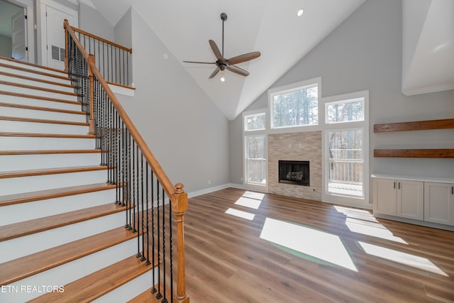 unfurnished living room featuring wood finished floors, baseboards, a fireplace, recessed lighting, and ceiling fan