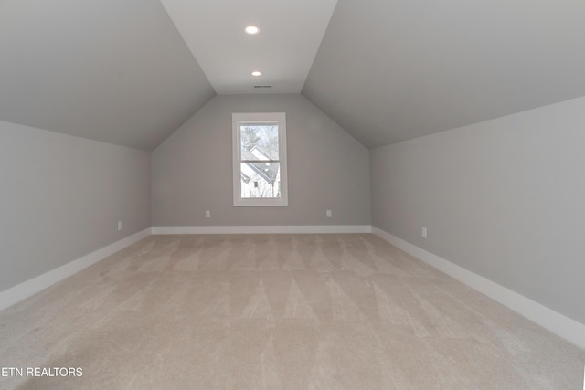 bonus room with lofted ceiling, recessed lighting, light colored carpet, and baseboards