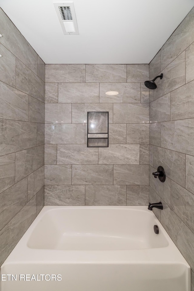 full bath featuring visible vents and tub / shower combination