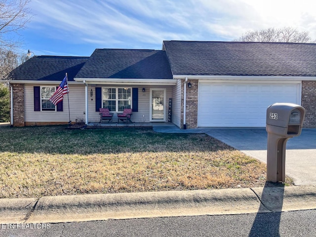 ranch-style house with a front yard, roof with shingles, concrete driveway, a garage, and brick siding