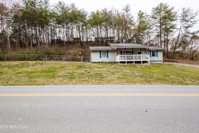 view of front of home featuring a front lawn and fence