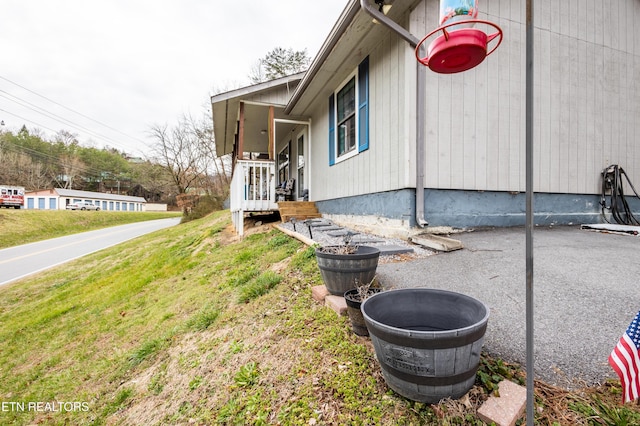 view of property exterior with a lawn