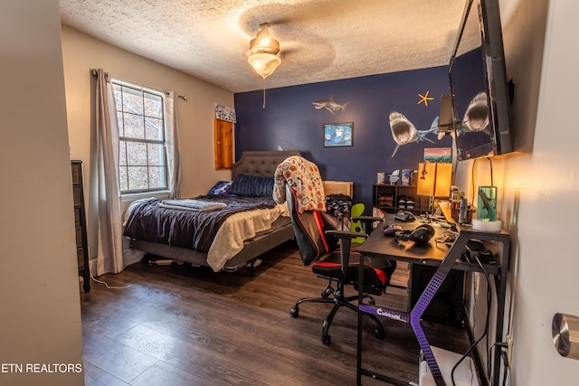 bedroom featuring a textured ceiling and wood finished floors