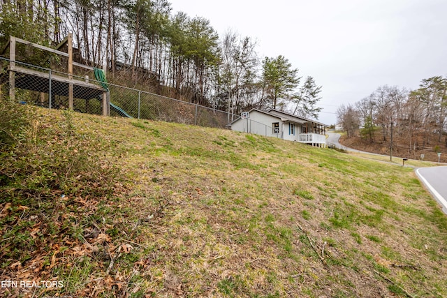 view of yard featuring a playground and fence