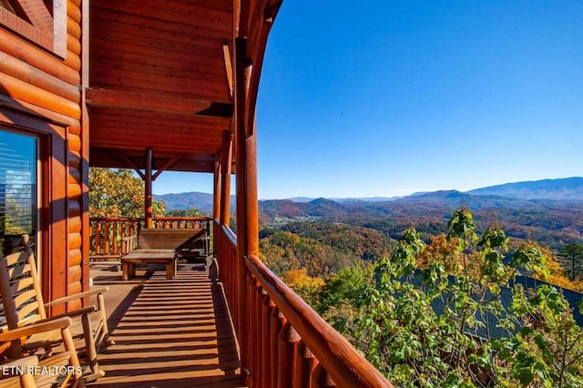 balcony with a wooded view and a mountain view