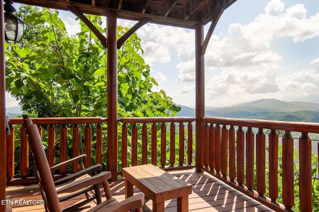 wooden deck featuring a mountain view