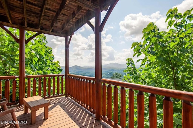 wooden deck featuring a mountain view