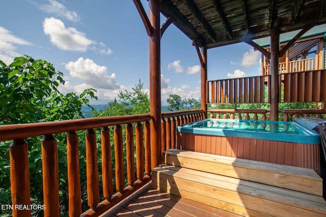 wooden deck with a hot tub