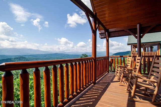 wooden deck featuring a mountain view