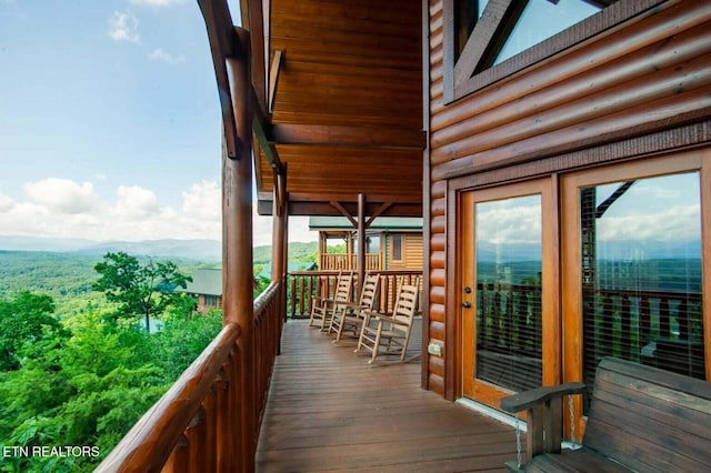 wooden deck with a mountain view