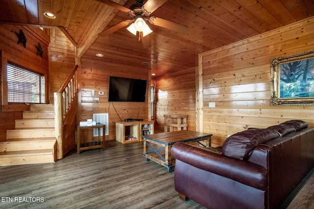 living room with wood finished floors, stairway, wood ceiling, and wood walls