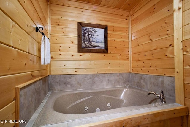 full bath featuring wood ceiling, wooden walls, and a jetted tub