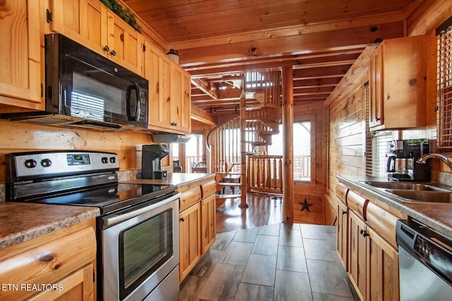 kitchen with dark wood-type flooring, wood walls, wood ceiling, stainless steel appliances, and a sink