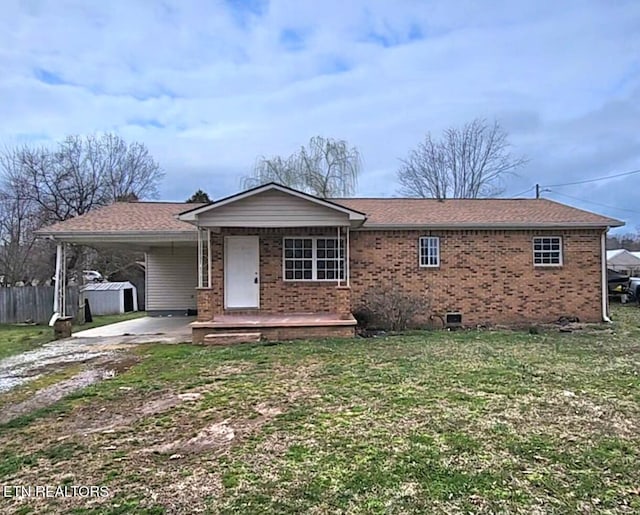 single story home featuring a carport, a front yard, brick siding, and driveway