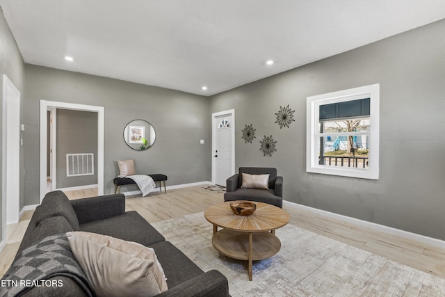 living room with visible vents, recessed lighting, baseboards, and wood finished floors