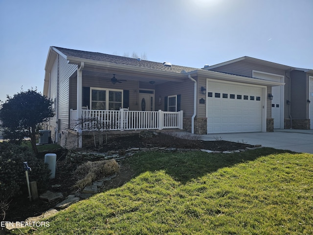 ranch-style home featuring a front yard, a ceiling fan, an attached garage, covered porch, and concrete driveway