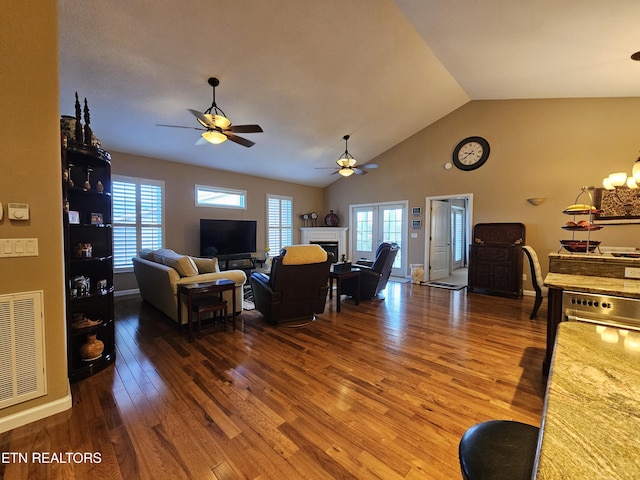 living room with a fireplace, wood finished floors, visible vents, and a healthy amount of sunlight