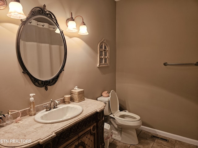 bathroom featuring vanity, toilet, baseboards, and visible vents