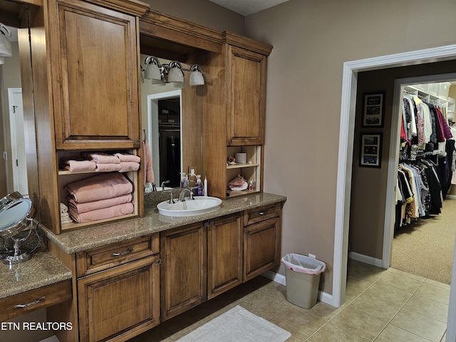 bathroom featuring tile patterned floors, vanity, and baseboards