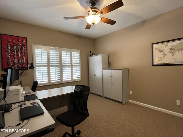 home office featuring baseboards, light colored carpet, and ceiling fan