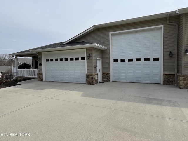 garage featuring concrete driveway