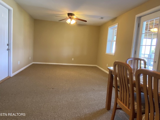 dining room featuring carpet flooring, visible vents, baseboards, and ceiling fan