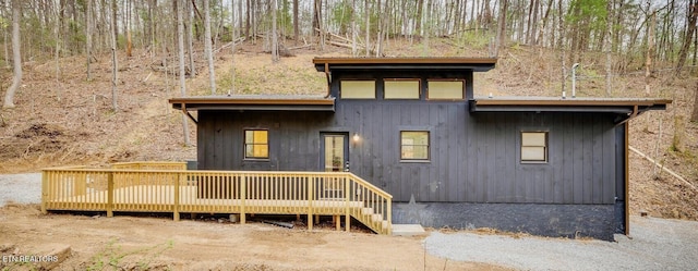 back of property featuring a wooden deck