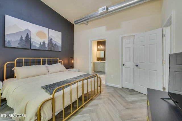 bedroom featuring visible vents, connected bathroom, and baseboards