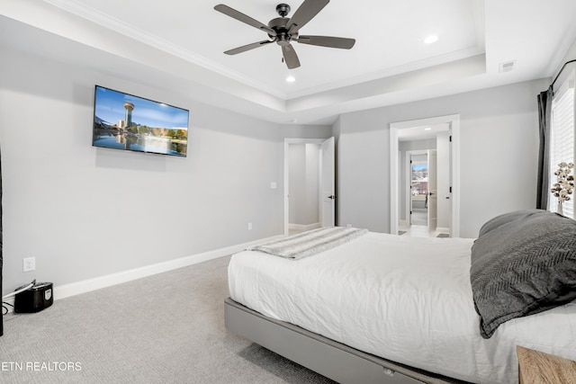 carpeted bedroom featuring a raised ceiling, recessed lighting, baseboards, and visible vents