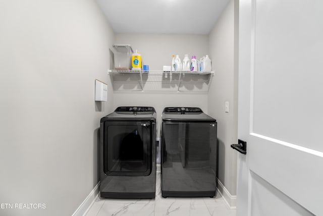 laundry room with washer and clothes dryer, laundry area, marble finish floor, and baseboards