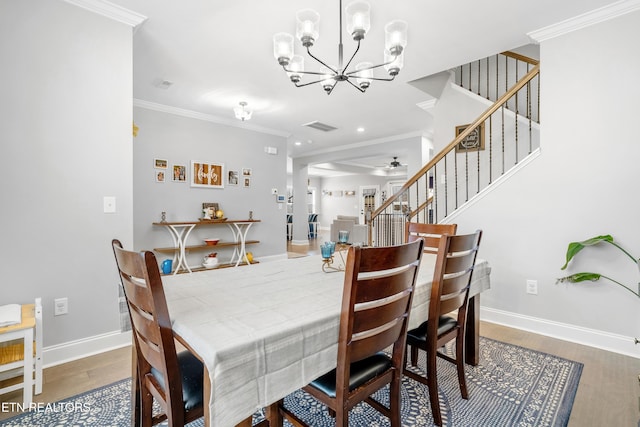 dining area with stairway, crown molding, baseboards, and wood finished floors