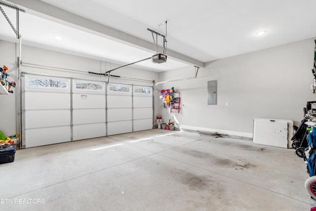 garage featuring electric panel, a garage door opener, and baseboards