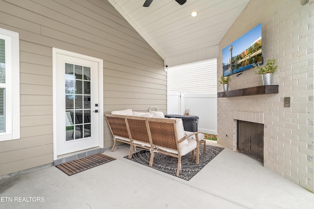 view of patio with an outdoor brick fireplace