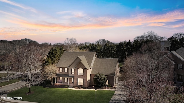 traditional home featuring a lawn