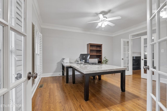 office with visible vents, ceiling fan, ornamental molding, french doors, and wood finished floors