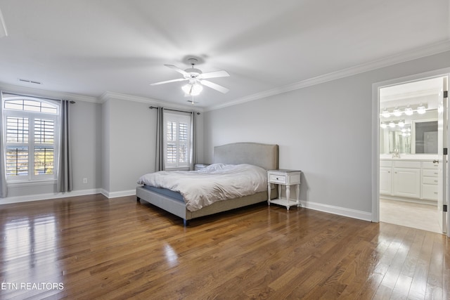 bedroom with a sink, baseboards, crown molding, and hardwood / wood-style flooring