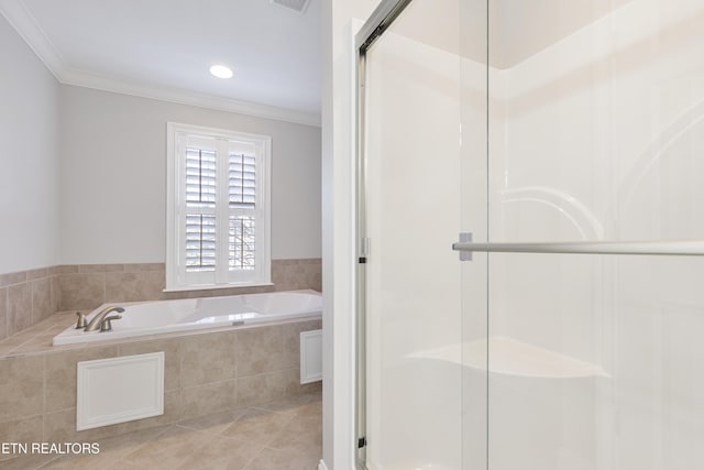 bathroom with a stall shower, a bath, crown molding, and tile patterned floors