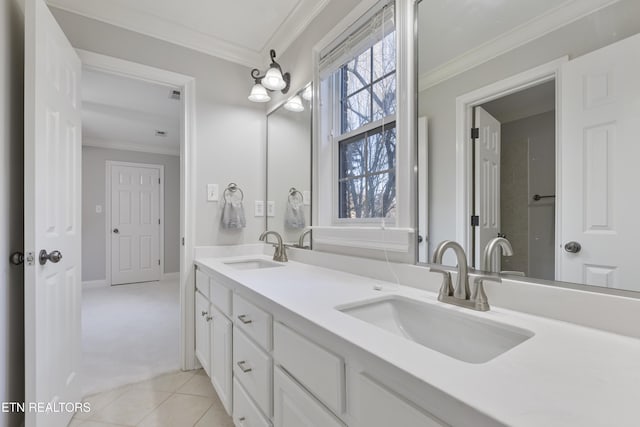 bathroom featuring a sink, double vanity, crown molding, and tile patterned floors